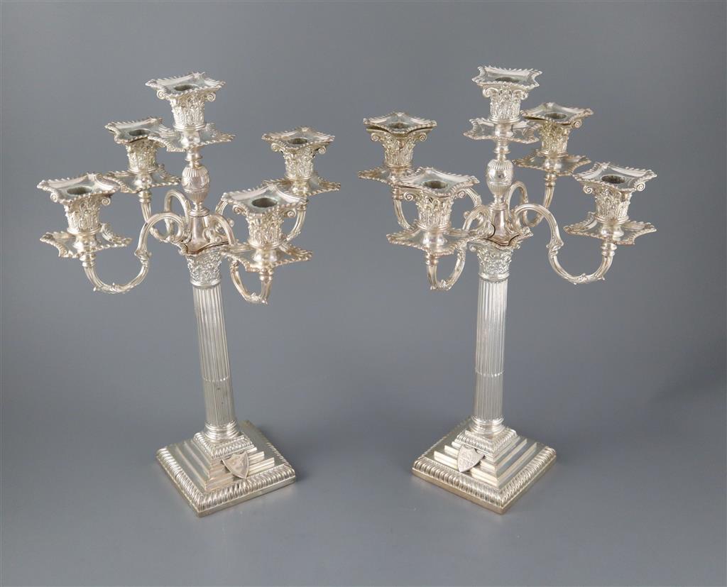 A pair of late Victorian silver corinthian column four branch, five light candelabra by Carrington & Co,